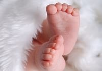 Baby feet on white velvet